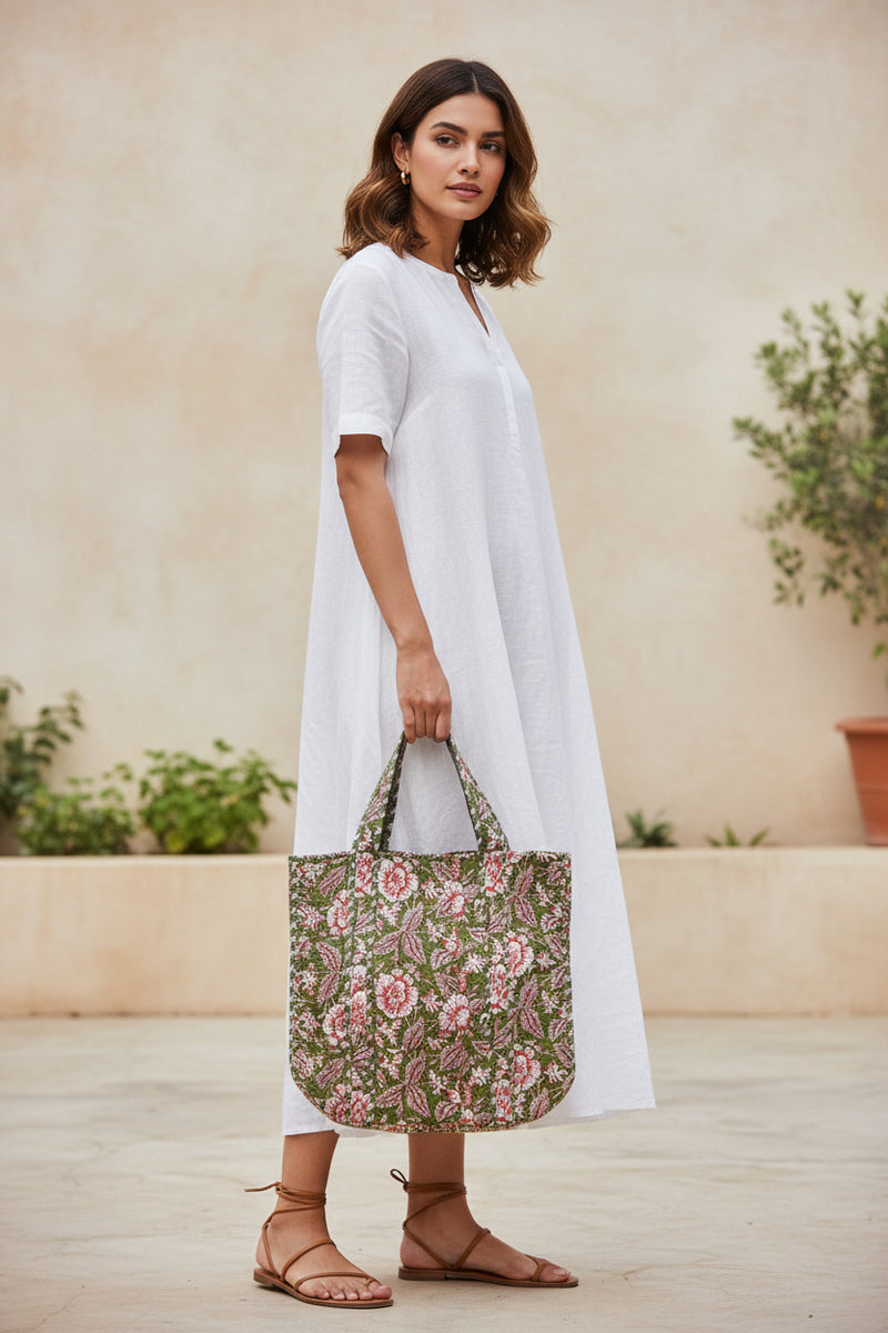 Floral patterned bag with red flowers on a green background