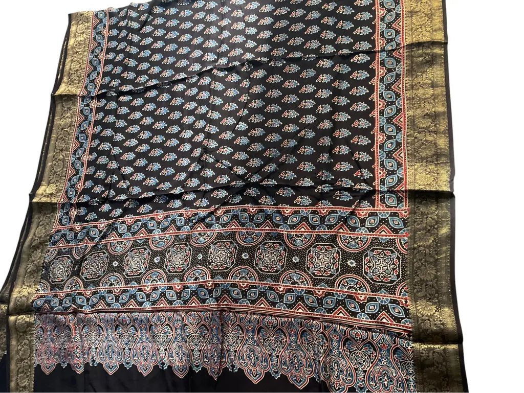 Close-up of paisley buti Ajrakh hand block print and gold zari border on black & ivory dola silk