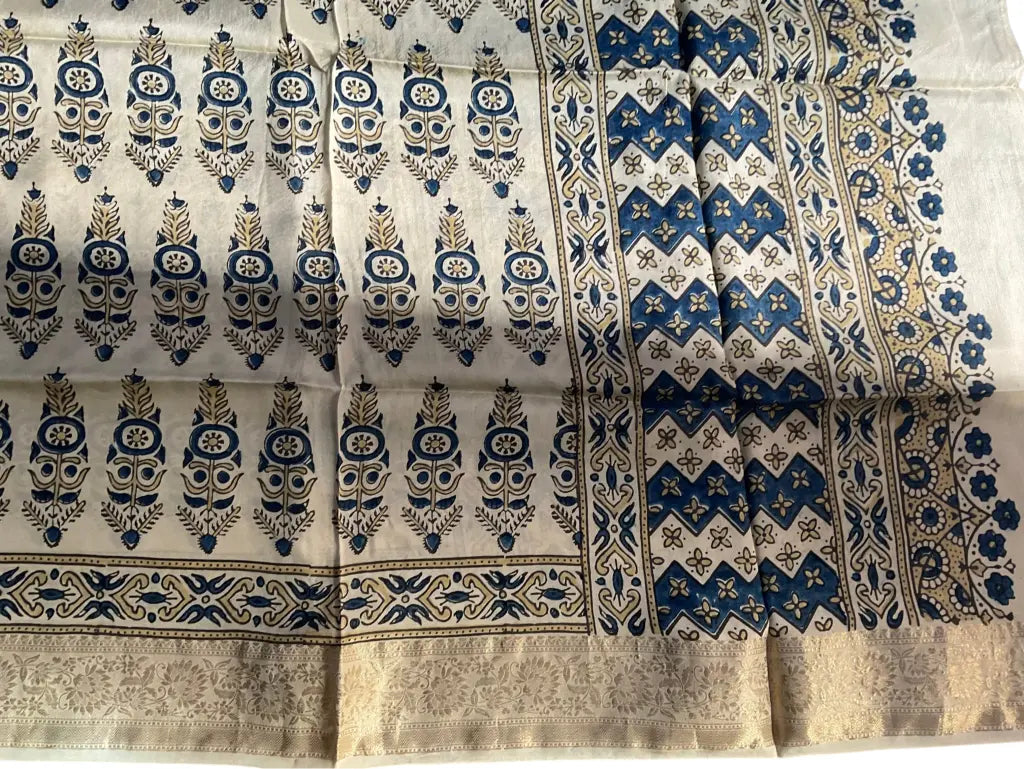 Close-up of cypress booti Ajrakh hand block print and gold zari border on cream & indigo dola silk