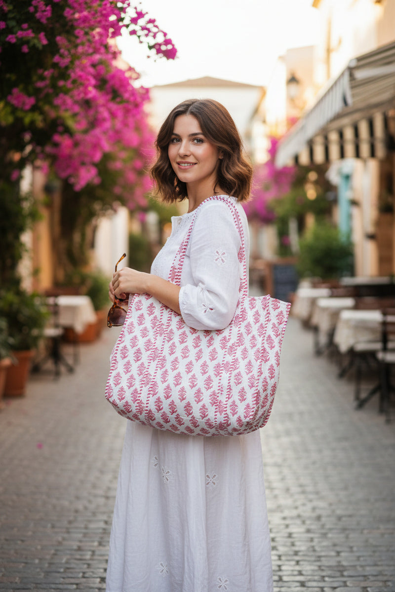 White tote bag with red floral pattern on a white background