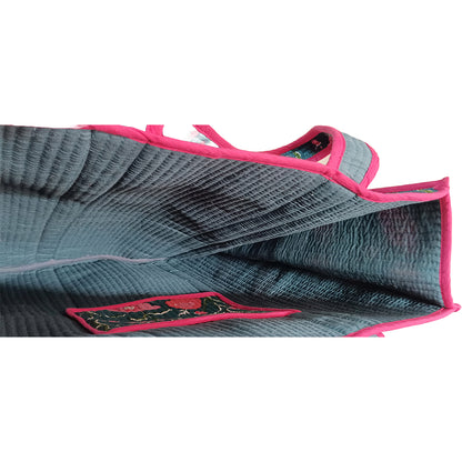 Gray athletic bra with pink trim on a white background