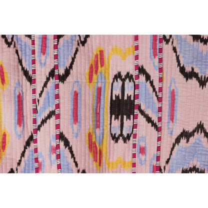 Close-up of a colorful patterned fabric with pink background