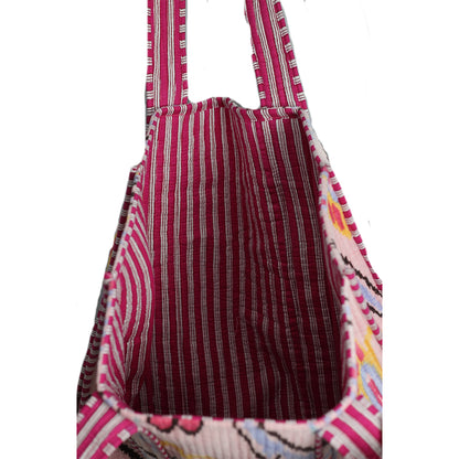 Close-up of a fabric bag with pink and brown pattern on a white background