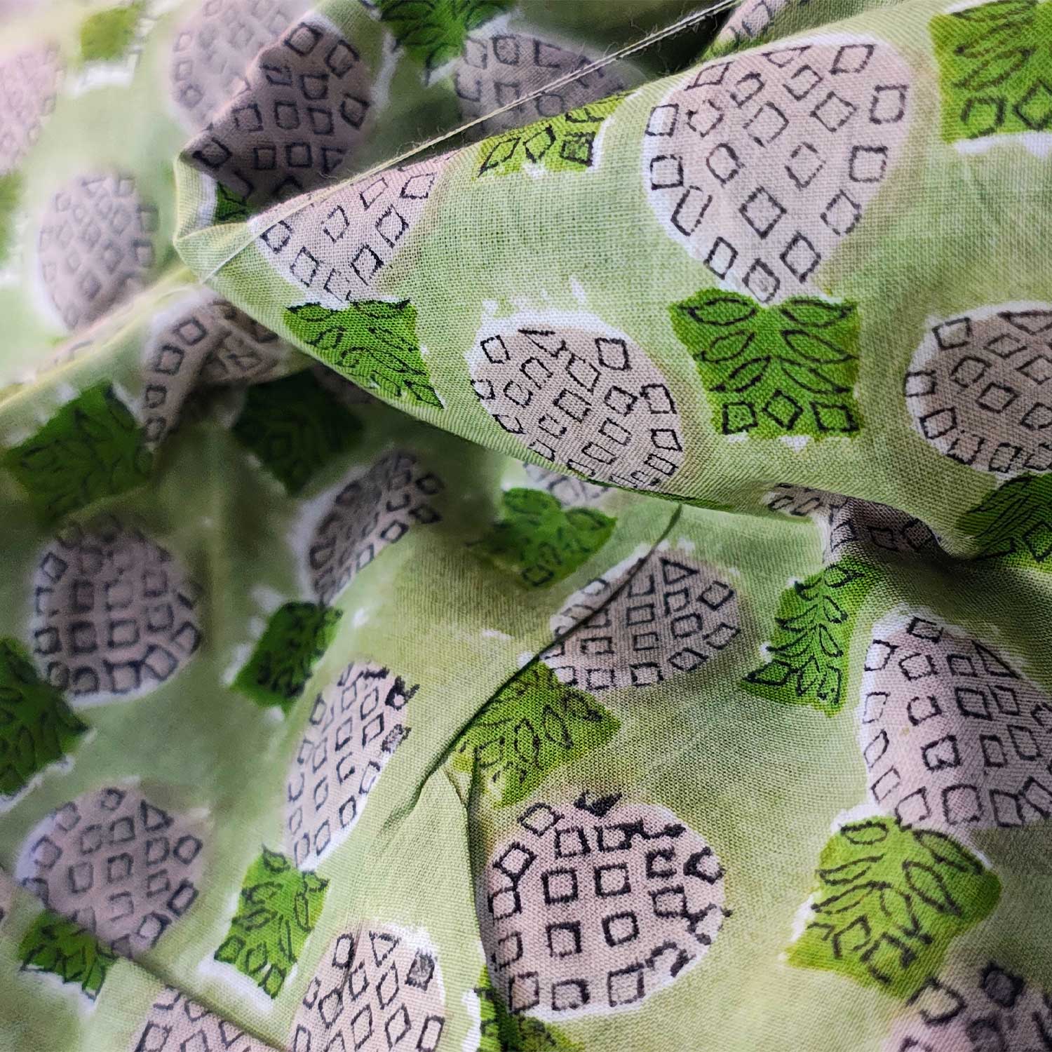 Close-up of green fabric with pineapple pattern