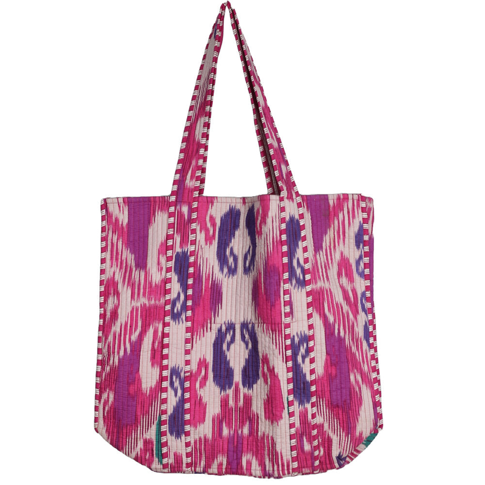 Pink and purple patterned bag with a strap on a white background