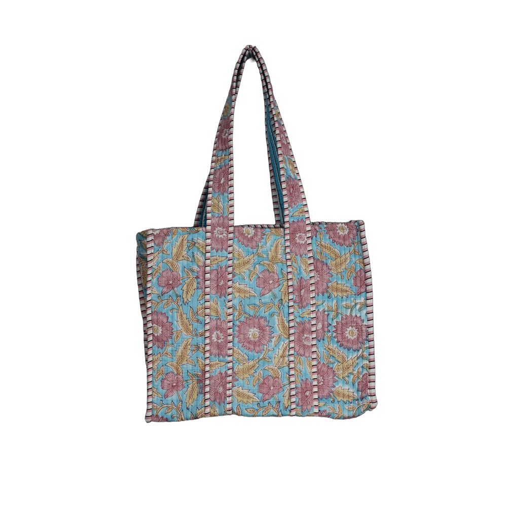 Floral patterned bag with a strap on a white background