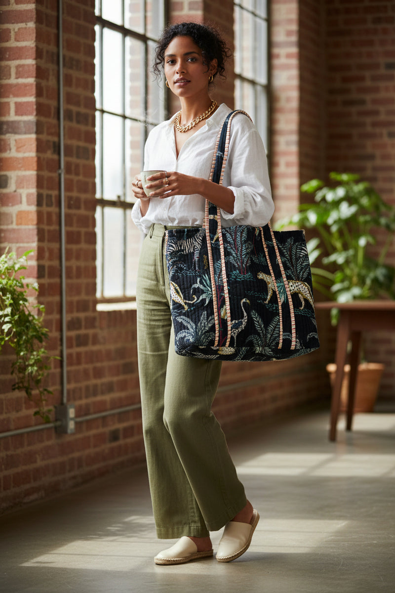 Tote bag with jungle animal pattern and striped handles on a white background