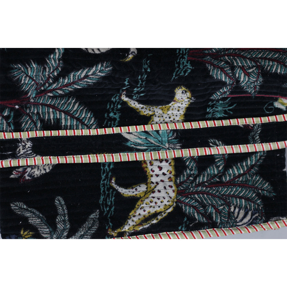 Textile with a leopard and leaf pattern on a black background