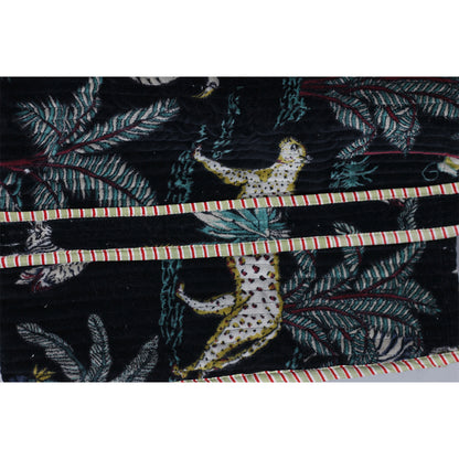 Textile with a leopard and leaf pattern on a black background