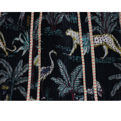 Jungle-themed fabric with leopards, birds, and foliage on a black background