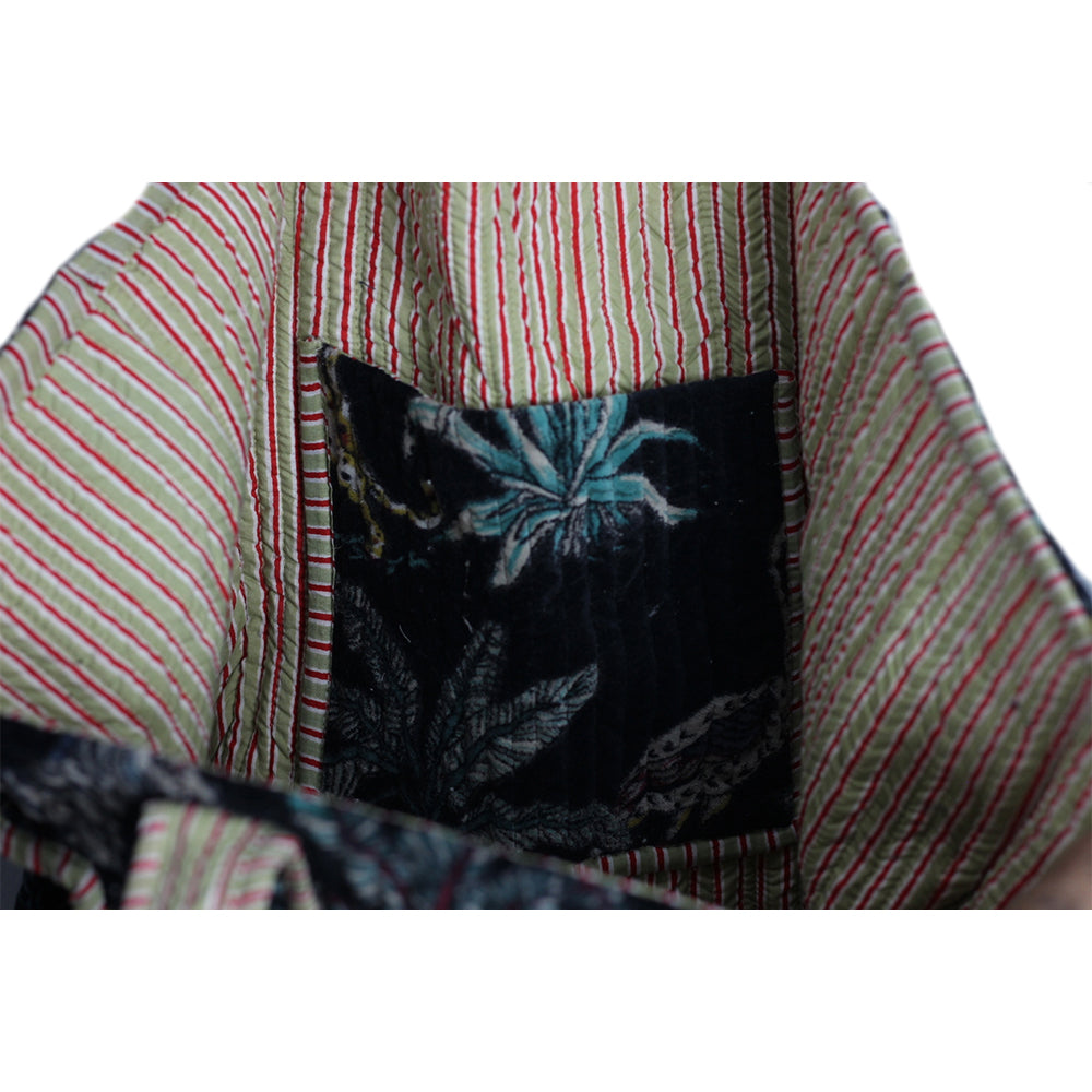 Close-up of a fabric with striped pattern and embroidered design.