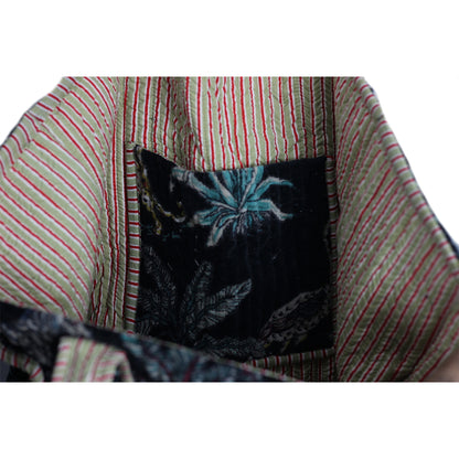 Close-up of a fabric with striped pattern and embroidered design.