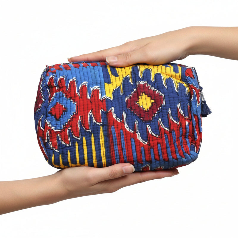 Colorful quilted pouch with geometric pattern on a white background