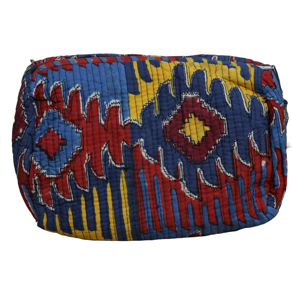Colorful quilted bag with geometric pattern on a white background