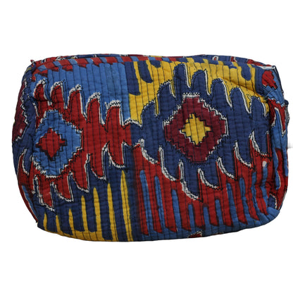 Colorful quilted bag with geometric pattern on a white background