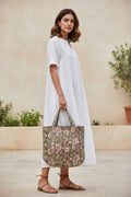 Floral patterned bag with red flowers on a green background
