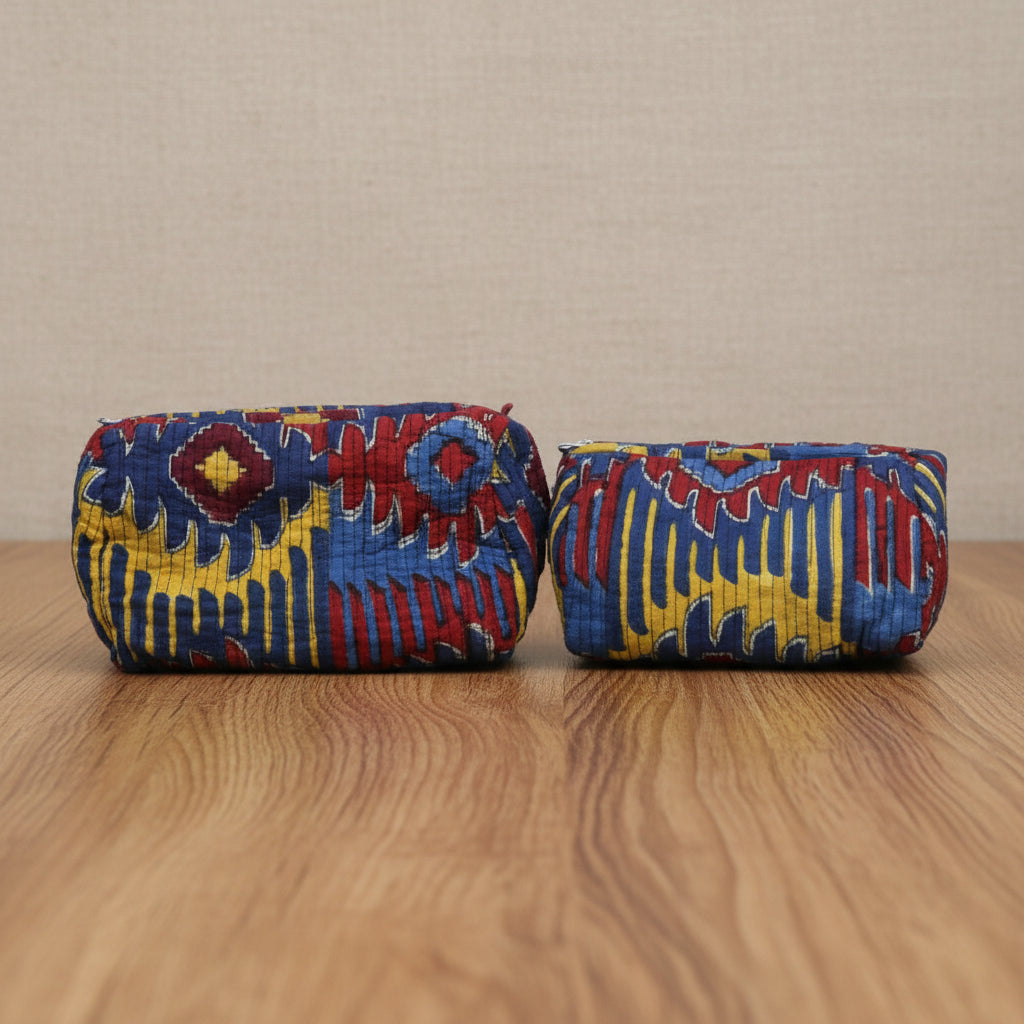 Three colorful cylindrical fabric rolls with a geometric pattern on a white background