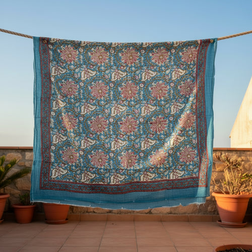 Blue floral patterned scarf with green leaves on a white background