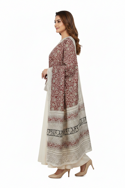 Woman wearing a long, patterned dress on a white background