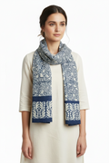 Woman wearing a patterned scarf on a white background