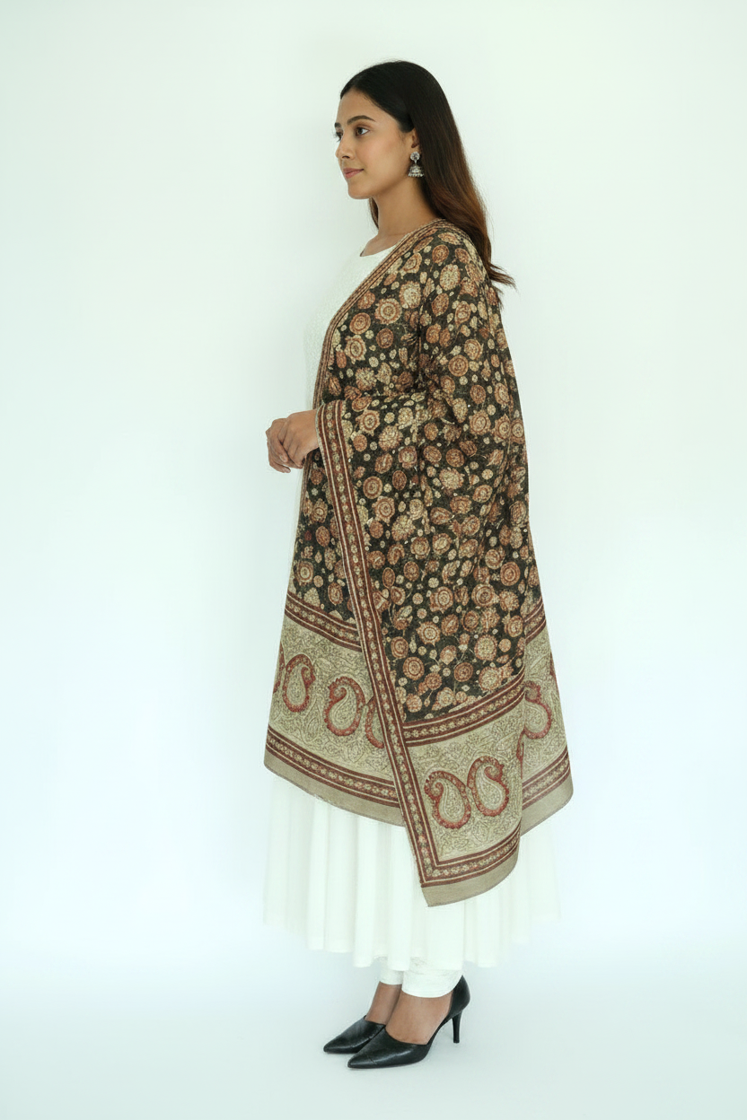 Woman wearing a patterned shawl over a plain outfit on a white background