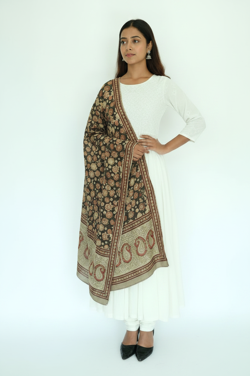 Woman wearing a white outfit with a patterned shawl on a white background