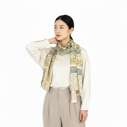 Woman wearing a patterned scarf on a white background