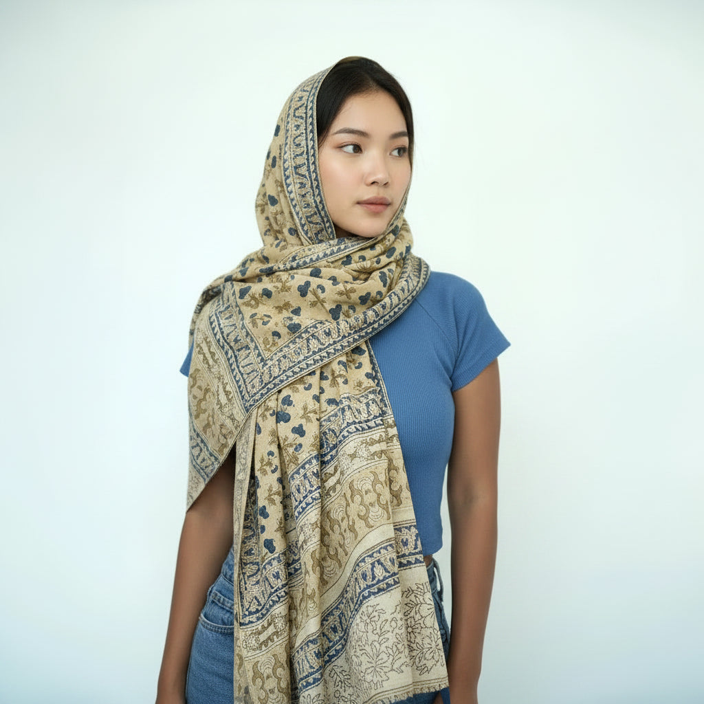 Woman wearing a patterned scarf on a white background