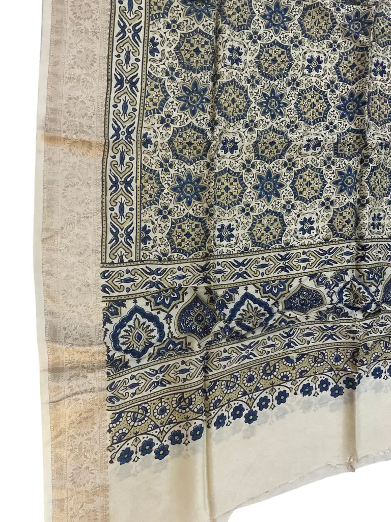 Close-up of star jaal Ajrakh hand block print and gold zari border on ivory & indigo dola silk