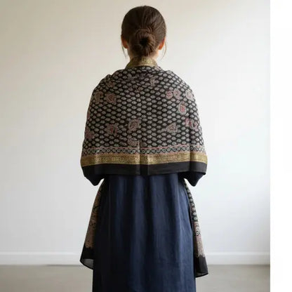 Black Ajrakh dola silk dupatta with gold zari border styled over a kurta