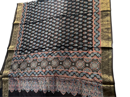 Close-up of paisley buti Ajrakh hand block print and gold zari border on black & ivory dola silk