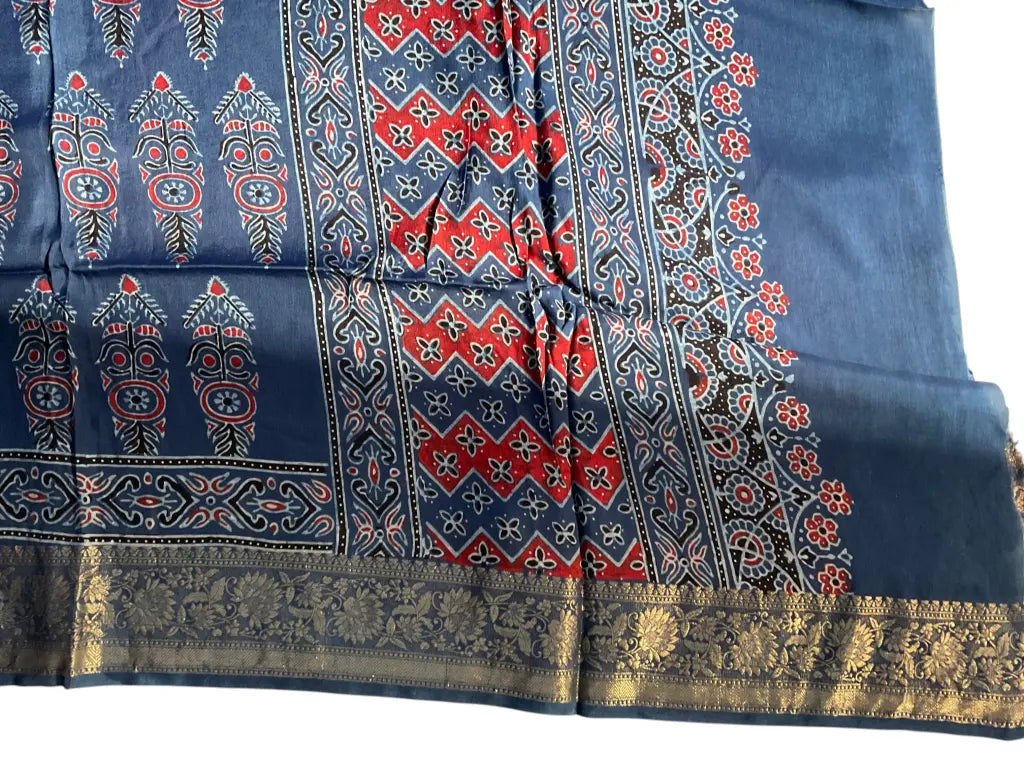 Close-up of cypress booti Ajrakh hand block print and gold zari border on indigo blue & red dola silk