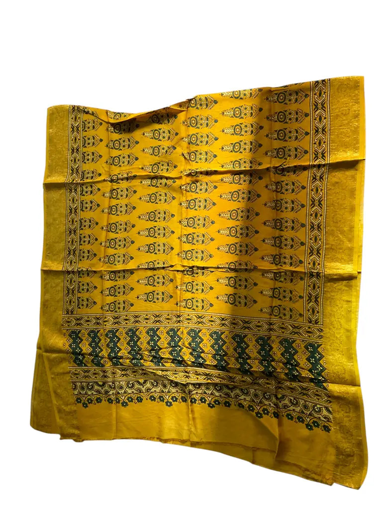 Turmeric Yellow & Teal hand block printed Ajrakh dupatta laid flat showing cypress booti print, pallu and zari border