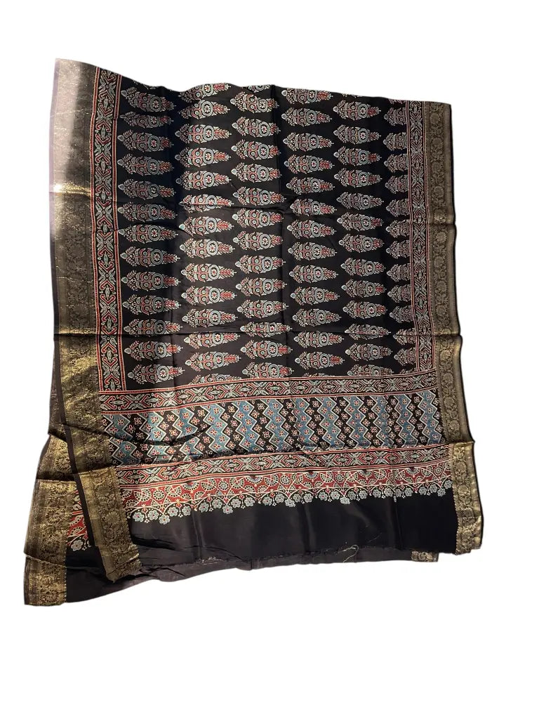 Black & Sky Blue hand block printed Ajrakh dupatta laid flat showing cypress booti print, pallu and zari border