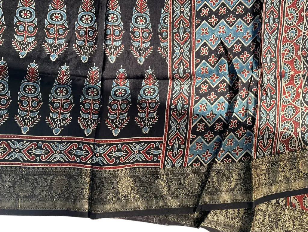 Close-up of cypress booti Ajrakh hand block print and gold zari border on black & sky blue dola silk