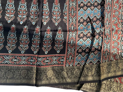 Close-up of cypress booti Ajrakh hand block print and gold zari border on black & sky blue dola silk