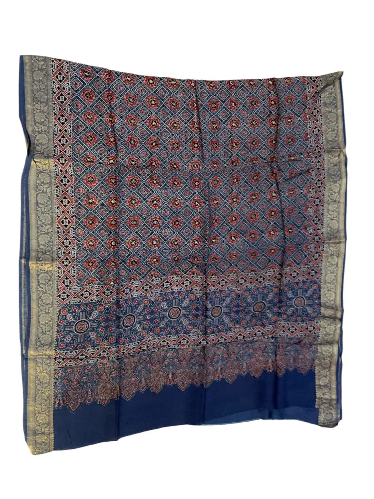 Indigo & Madder hand block printed Ajrakh dupatta laid flat showing geometric jaal print, pallu and zari border