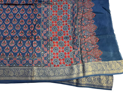 Close-up of red star pallu Ajrakh hand block print and gold zari border on indigo blue dola silk