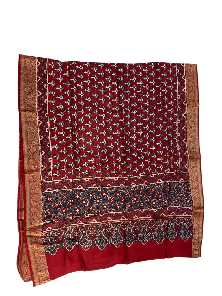 Maroon Red hand block printed Ajrakh dupatta laid flat showing indigo floral buti print, pallu and zari border