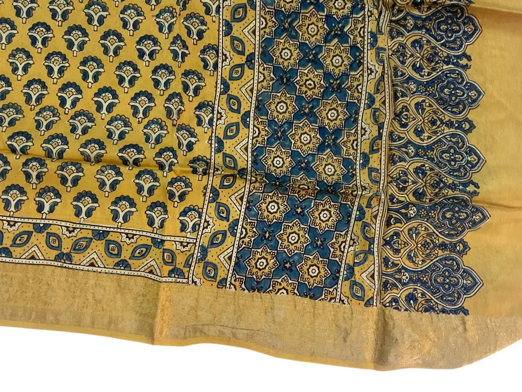 Close-up of star pallu Ajrakh hand block print and gold zari border on mustard & teal dola silk