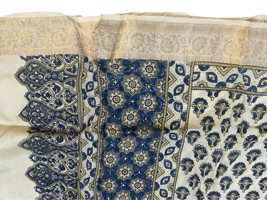 Close-up of paisley buti Ajrakh hand block print and pale gold zari border on ivory & indigo dola silk