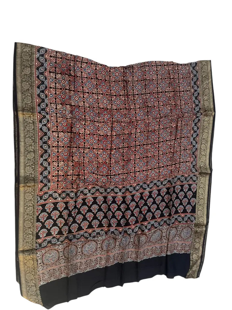 Rust & Black hand block printed Ajrakh dupatta laid flat showing geometric grid print, pallu and zari border