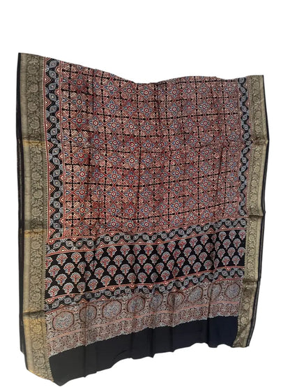 Rust & Black hand block printed Ajrakh dupatta laid flat showing geometric grid print, pallu and zari border