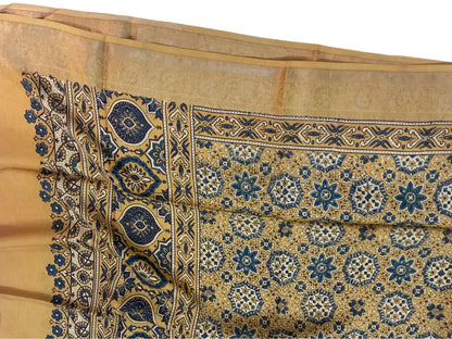 Close-up of indigo star jaal Ajrakh hand block print and gold zari border on ochre dola silk