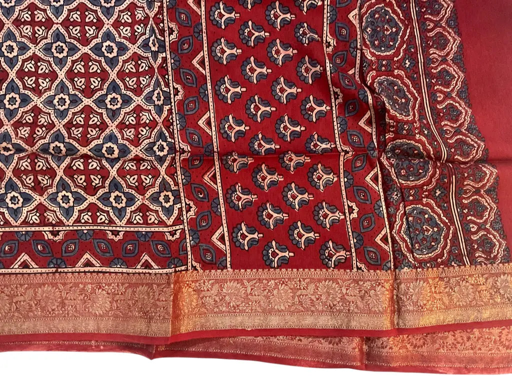 Close-up of lattice jaal Ajrakh hand block print and red-gold zari border on madder red & ivory dola silk