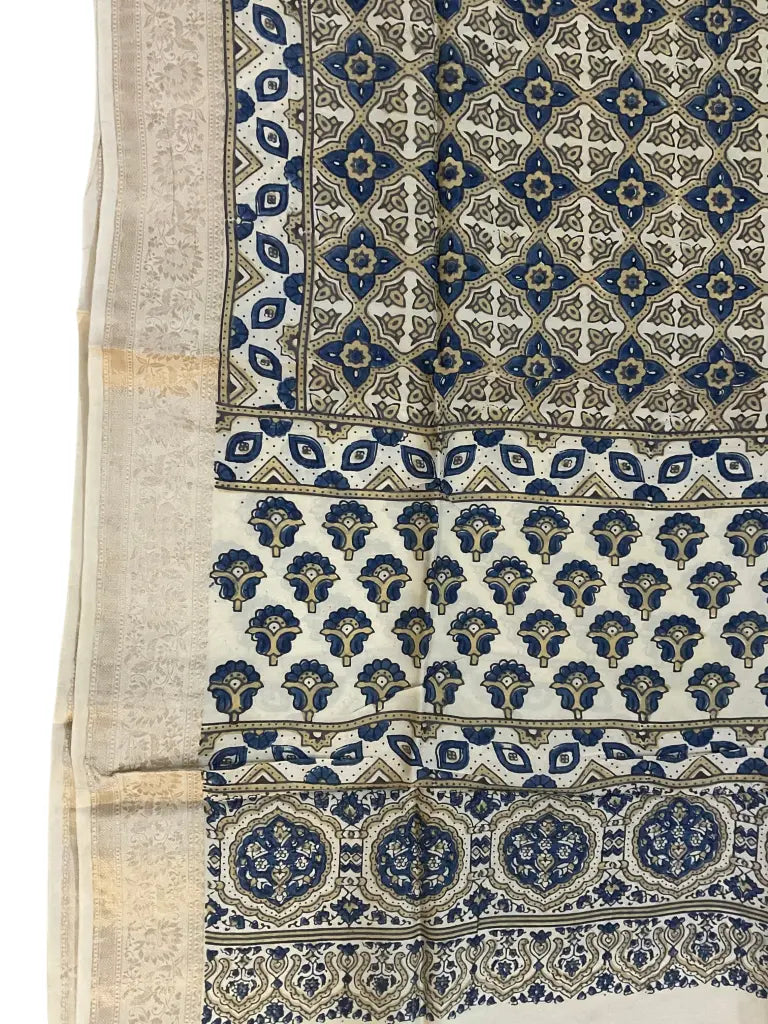 Close-up of geometric jaal Ajrakh hand block print and pale gold zari border on cream & indigo dola silk