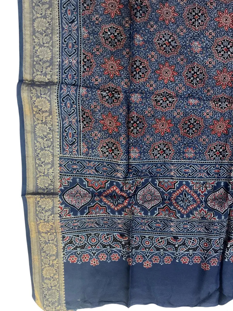Close-up of star jaal Ajrakh hand block print and gold zari border on indigo blue & red dola silk
