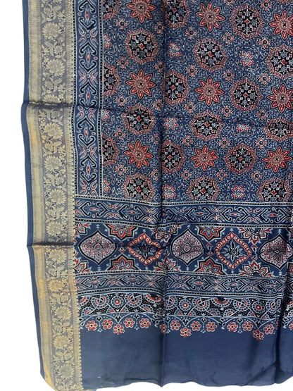 Close-up of star jaal Ajrakh hand block print and gold zari border on indigo blue & red dola silk