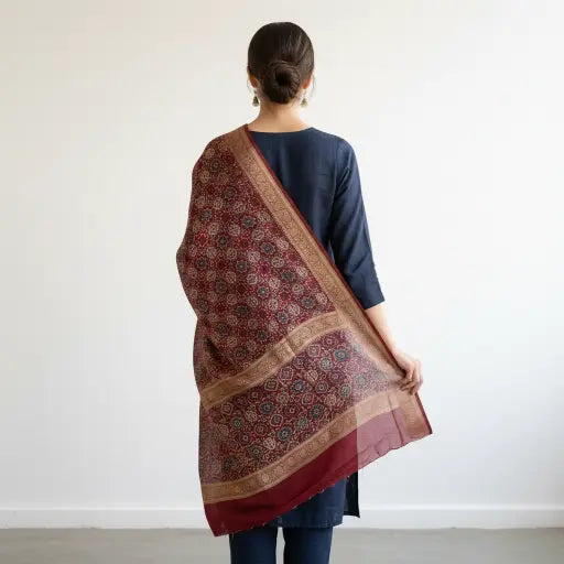 Wine Maroon Ajrakh dola silk dupatta with gold zari border styled over a kurta
