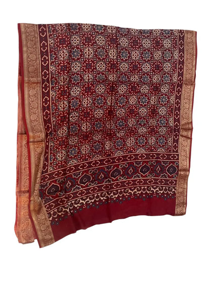 Wine Maroon hand block printed Ajrakh dupatta laid flat showing medallion jaal print, pallu and zari border